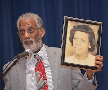gregory cooke with a framed photo of his-mother