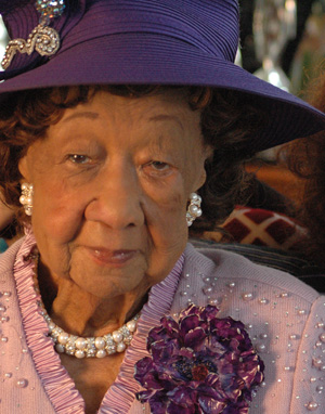 Dr. Dorothy Height wearing a purple hat